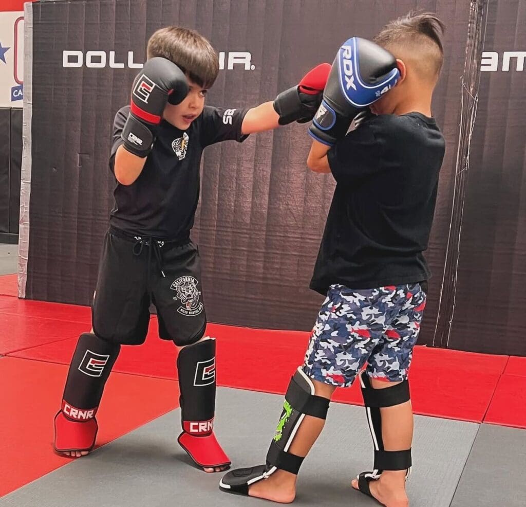 Happy kids in Gardena learning Muay Thai, improving balance, coordination, and having fun while building life skills.